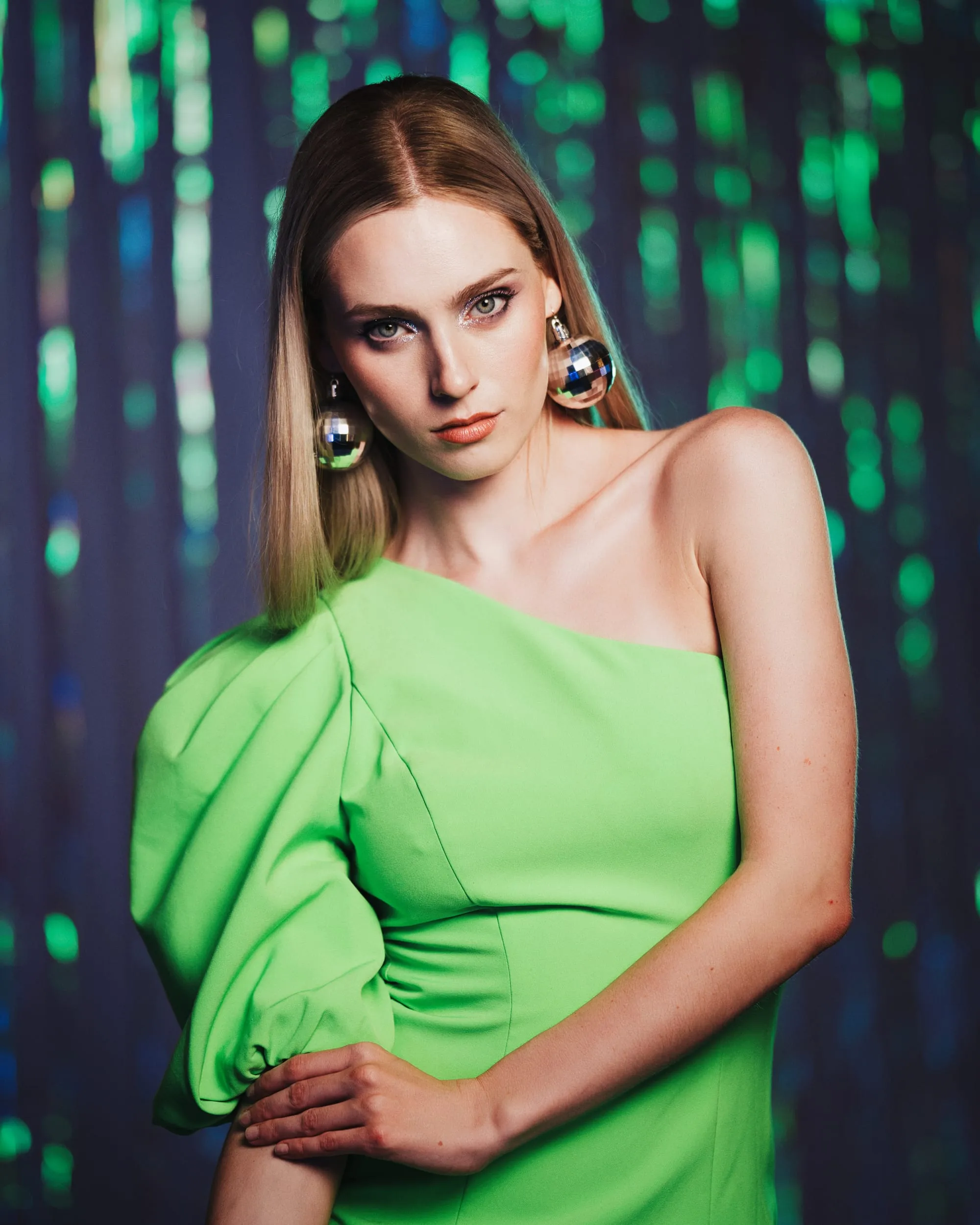 editorial portrait green dress disco earrings